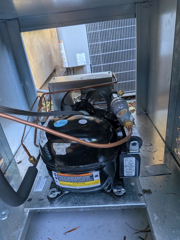 Compressor inside the outdoor condensing unit of a wine cellar split system