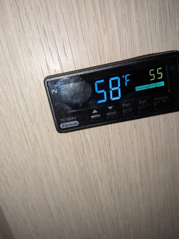 Wine cellar temperature controller showing 58°F against a 55°F setpoint