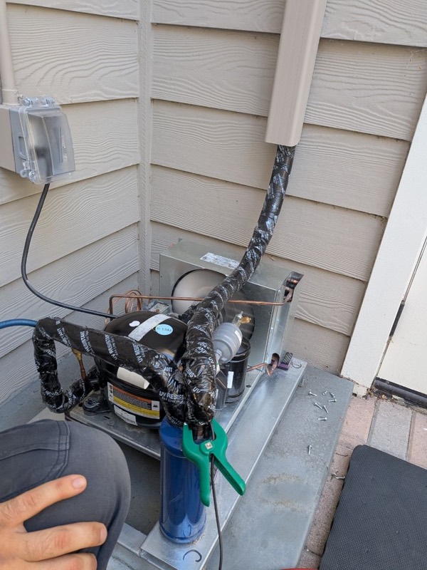 Refrigerant gauges connected to an outdoor wine cellar condensing unit