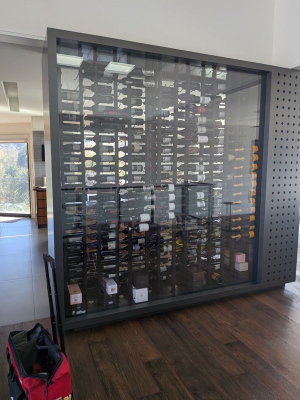 Glass-walled wine room on a Fortex wine cellar cooling service call