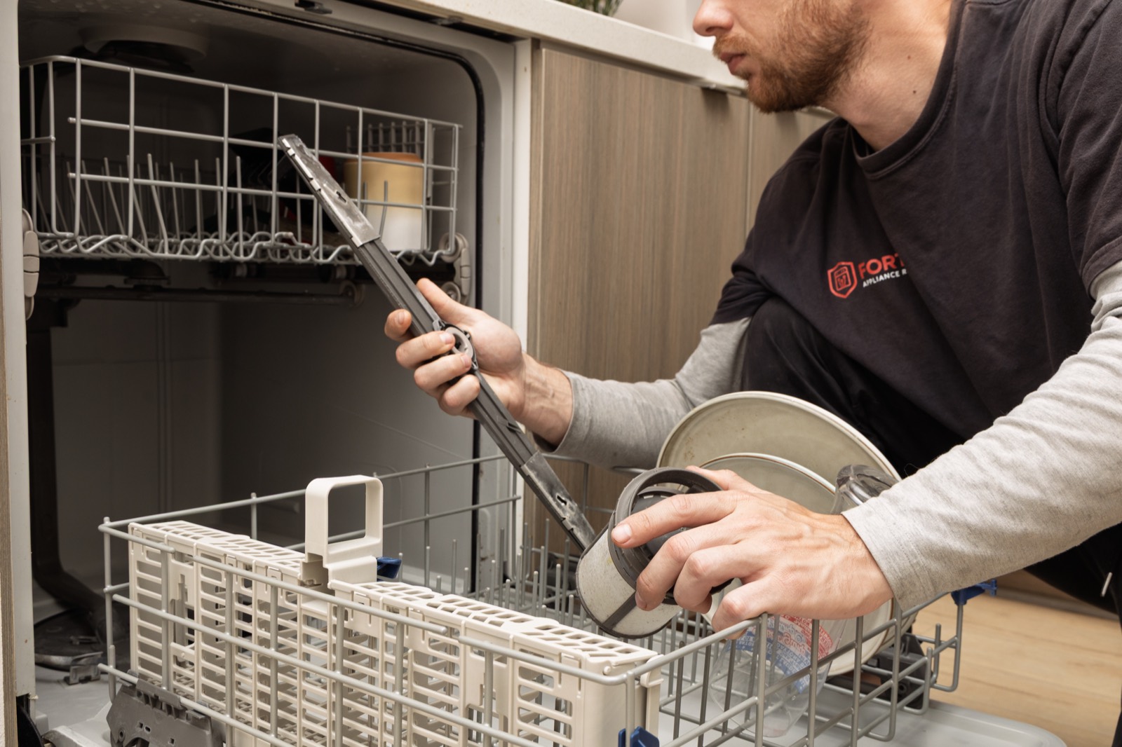 Fortex technician servicing a dishwasher spray arm