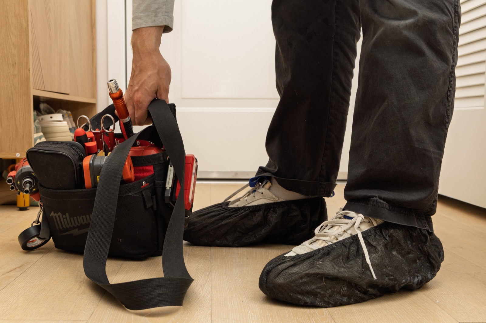 Fortex technician's tool bag and protective shoe covers on a clean kitchen floor